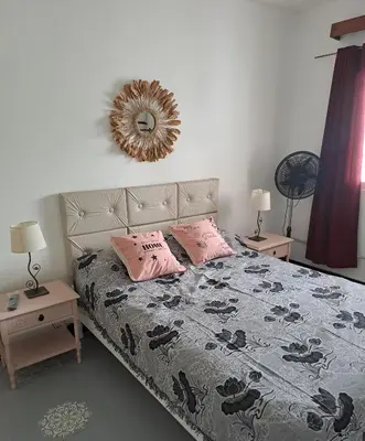 a bedroom with a bed with two pink pillows at Achalay in Bialet Massé