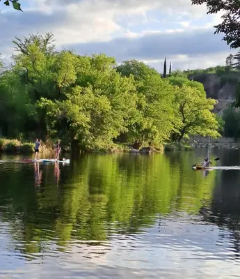 a group of people are on a body of water at Achalay in Bialet Massé