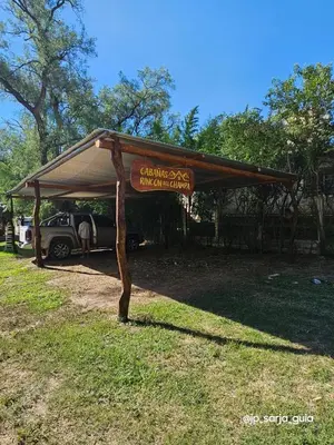 a tent with a car parked under it at Cabañas Rincon del Champa in San Javier