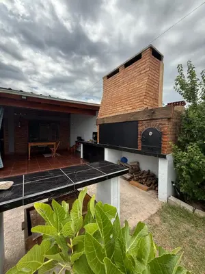 a backyard with a brick oven and a patio at Quincho El Aguaribay in Villa Dolores