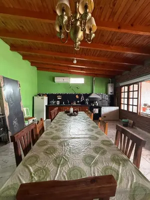 a large dining room with a large table with chairs at Quincho El Aguaribay in Villa Dolores