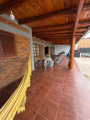 a patio with a fence and a table and chairs at Quincho El Aguaribay in Villa Dolores