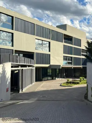a large building with a parking lot in front of it at Departamento 103 - Puerto del Aguila Country Nautico in Potrero de Garay