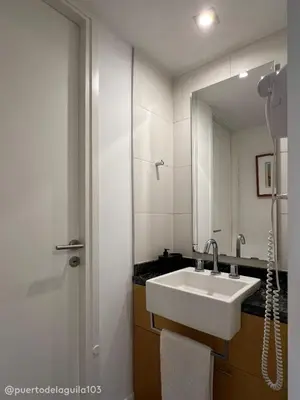 a bathroom with a sink and a mirror at Departamento 103 - Puerto del Aguila Country Nautico in Potrero de Garay