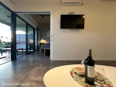 a bottle of wine sitting on a table in a living room at Departamento 103 - Puerto del Aguila Country Nautico in Potrero de Garay