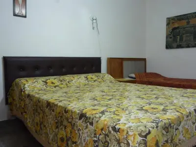 a bedroom with a bed with a floral bedspread at MariaAurelia in Mina Clavero