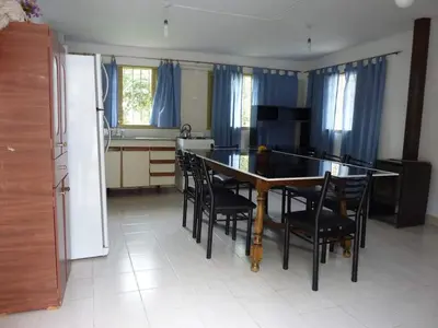 a kitchen with a table and chairs and a refrigerator at MariaAurelia in Mina Clavero