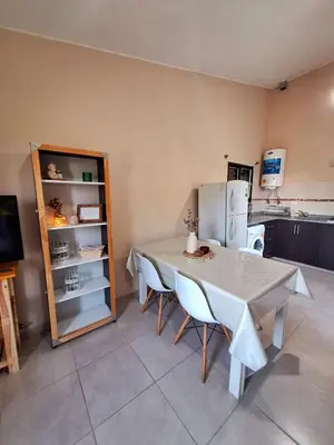 a kitchen with a table and chairs and a refrigerator at Estancia del Alma in Villa Carlos Paz