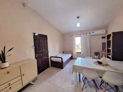 a room with a dining table and a bedroom with a bed at Estancia del Alma in Villa Carlos Paz