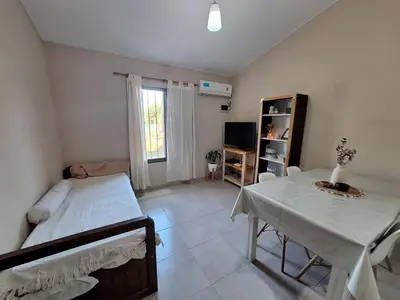a room with a bed and a table and a television at Estancia del Alma in Villa Carlos Paz