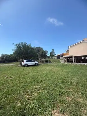 a car parked in a field next to a building at Estancia del Alma in Villa Carlos Paz
