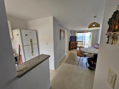 a kitchen and dining room with a table and a refrigerator at DEPTO con piscina Climatizada para 6 in Malagueño