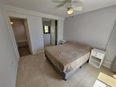 a bedroom with a bed and a ceiling fan at DEPTO con piscina Climatizada para 6 in Malagueño