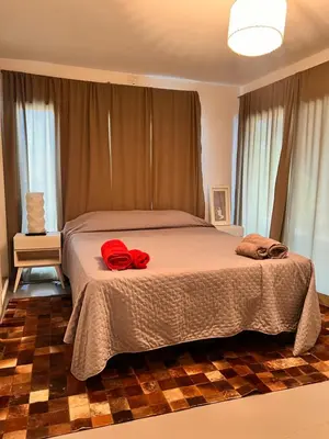 a bedroom with a bed with two towels on it at Cerro Plaza departamento in Cordoba