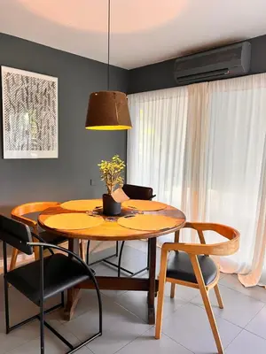 a dining room with a wooden table and chairs at Cerro Plaza departamento in Cordoba