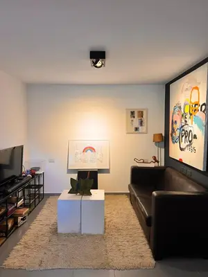 a living room with a couch and a flat screen tv at Cerro Plaza departamento in Cordoba
