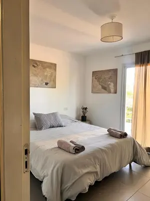 a bedroom with a large bed with two pillows on it at Cerro Plaza departamento in Cordoba