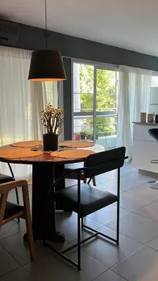 a dining room table with a potted plant on it at Cerro Plaza departamento in Cordoba