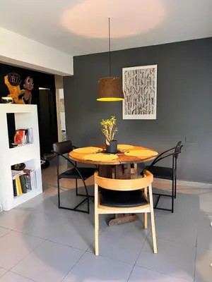 a dining room with a wooden table and chairs at Cerro Plaza departamento in Cordoba