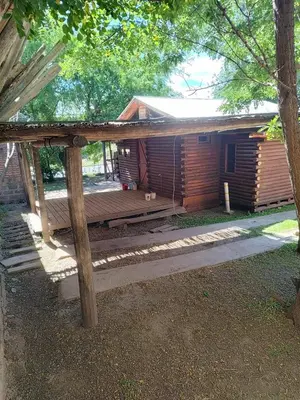 a wooden deck in front of a log cabin at Cabana Consuelo in San Roque