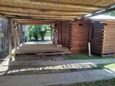a wooden cabin with a wooden floor and a porch at Cabana Consuelo in San Roque