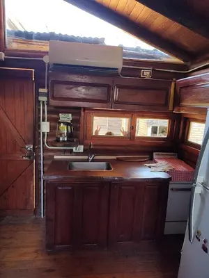 a kitchen with wooden cabinets and a sink at Cabana Consuelo in San Roque