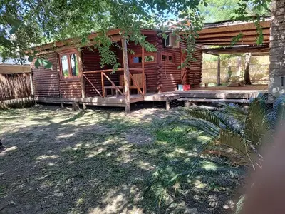 a log cabin with a porch and a deck at Cabana Consuelo in San Roque
