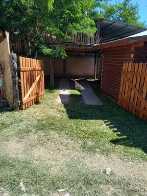 a backyard with a wooden fence and a shed at Cabana Consuelo in San Roque