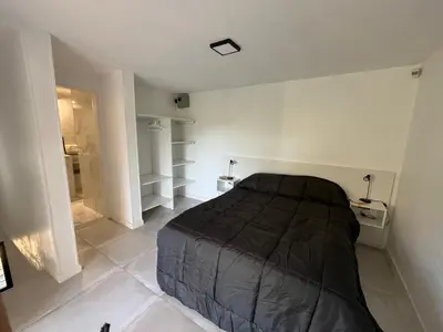 a bedroom with a bed and a walk in shower at Sierra y Lago in Villa Parque Siquiman