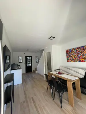 a living room with a table and chairs and a couch at Sierra y Lago in Villa Parque Siquiman