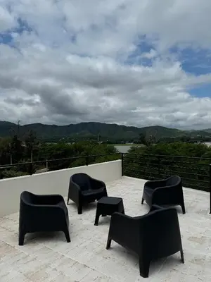 a group of black chairs sitting on a patio at Sierra y Lago in Villa Parque Siquiman