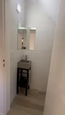 a bathroom with a sink and a mirror at Sierra y Lago in Villa Parque Siquiman