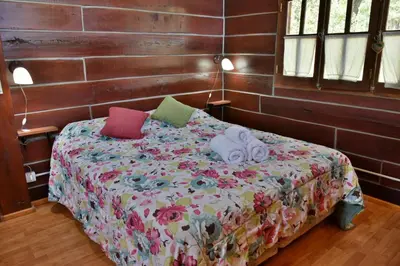 a bedroom with a bed with pillows on it at Villa Armonia in Los Reartes