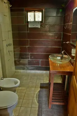 a bathroom with a sink and a toilet and a tub at Villa Armonia in Los Reartes