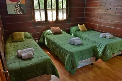 a room with three beds with stuffed animals on them at Villa Armonia in Los Reartes