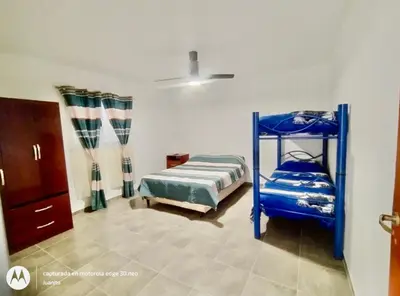 a bedroom with a blue bunk bed in a room at Departamentos Don Luis in Villa Cura Brochero