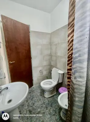 a bathroom with a toilet and a sink at Departamentos Don Luis in Villa Cura Brochero