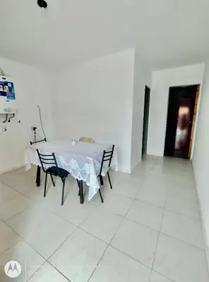 a dining room with a white table and chairs at Departamentos Don Luis in Villa Cura Brochero