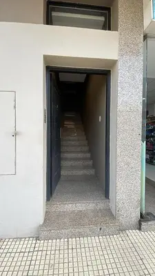 a hallway of a building with a door and stairs at Departamento hasta 4 personas Villa Dolores in Villa Dolores