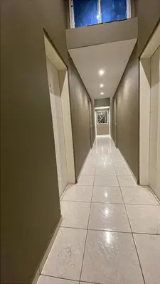 a hallway with a tile floor and a ceiling at Departamento hasta 4 personas Villa Dolores in Villa Dolores