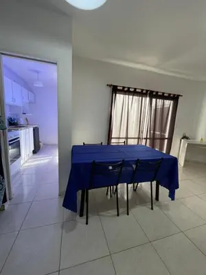 a blue table with four chairs in a kitchen at Departamento hasta 4 personas Villa Dolores in Villa Dolores