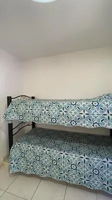 a bench in a room with a blue and white pillow at Departamento hasta 4 personas Villa Dolores in Villa Dolores
