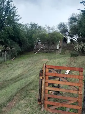 a wooden fence in the middle of a field at La Loma in Villa del Dique