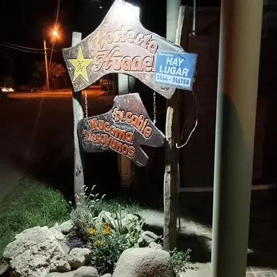 a sign on the side of a street at night at Hostería HuAneL in Villa Cura Brochero