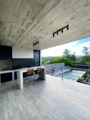 a room with a table and chairs on a balcony at Casa lujosa en Tanti in Tanti