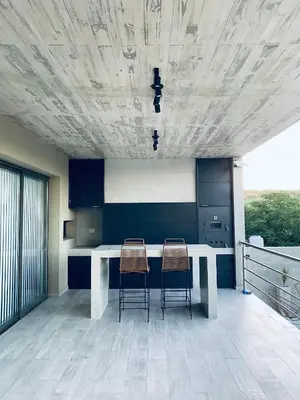 a kitchen with a white table and two chairs at Casa lujosa en Tanti in Tanti