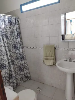 a bathroom with a shower curtain and a sink at La Calma in Los Reartes
