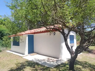 a small white building with a tree in front of it at La Calma in Los Reartes