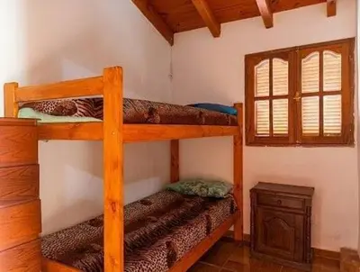 a bedroom with two bunk beds and a window at Brisas Serranas Departamentos in Villa Carlos Paz