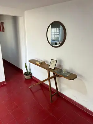 a table in a room with a mirror on the wall at Casa Henry in Cordoba